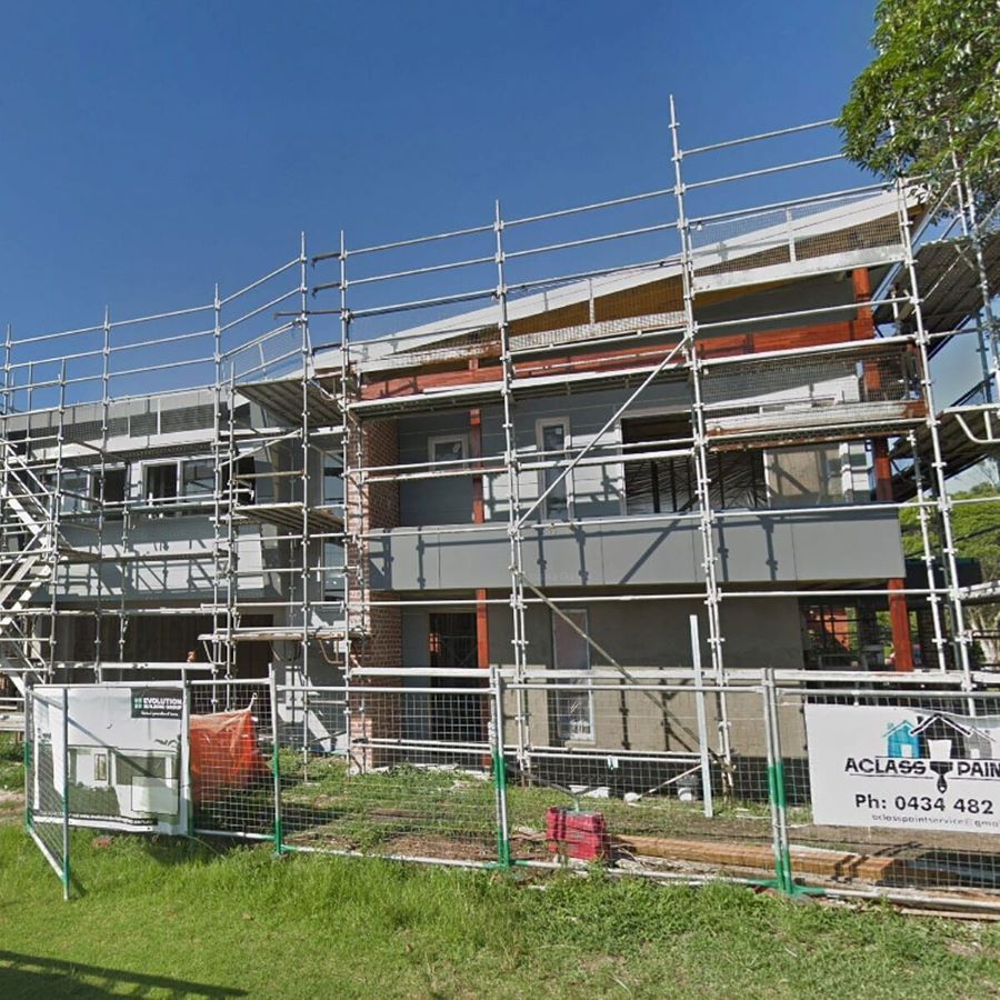 A Building Under Construction with Scaffolding and A Sign that Says Acland on It — Evolution Building Group Dapto, NSW