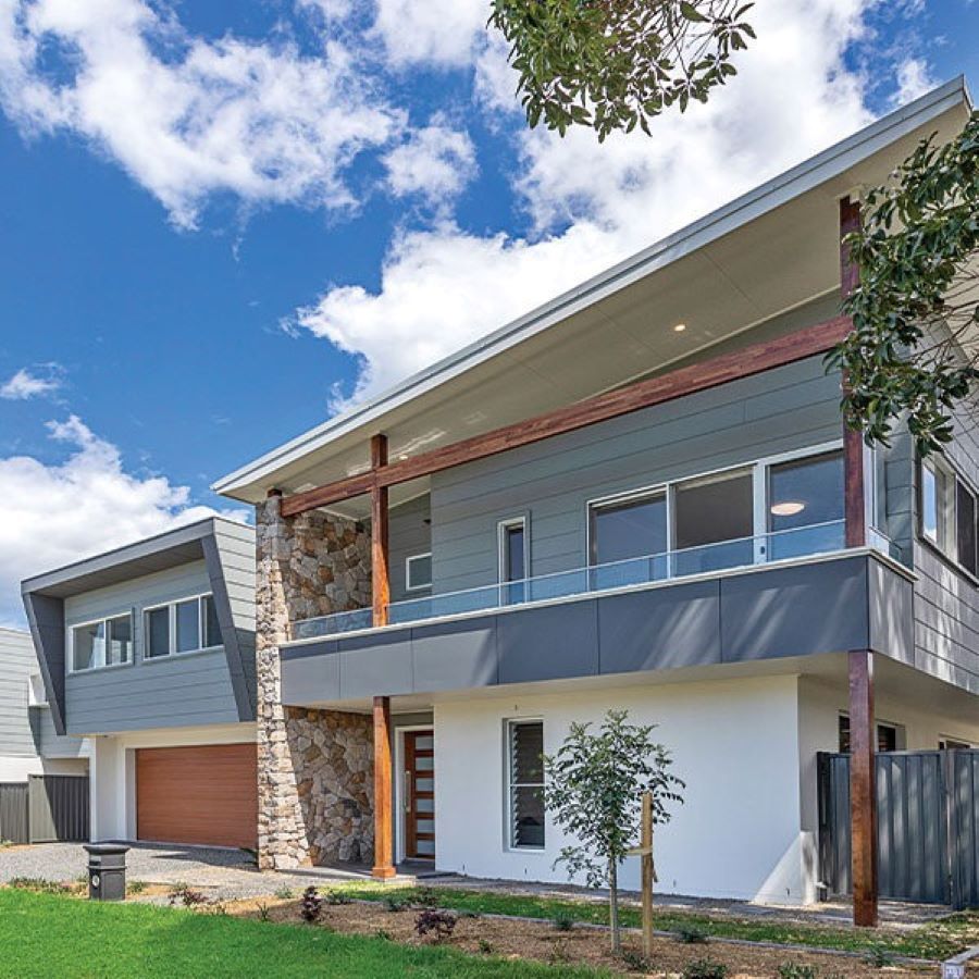 A Large House with A Lot of Windows and A Balcony — Evolution Building Group Dapto, NSW