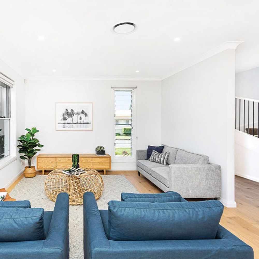 A Living Room with A Couch , Chairs and A Coffee Table — Evolution Building Group Dapto, NSW