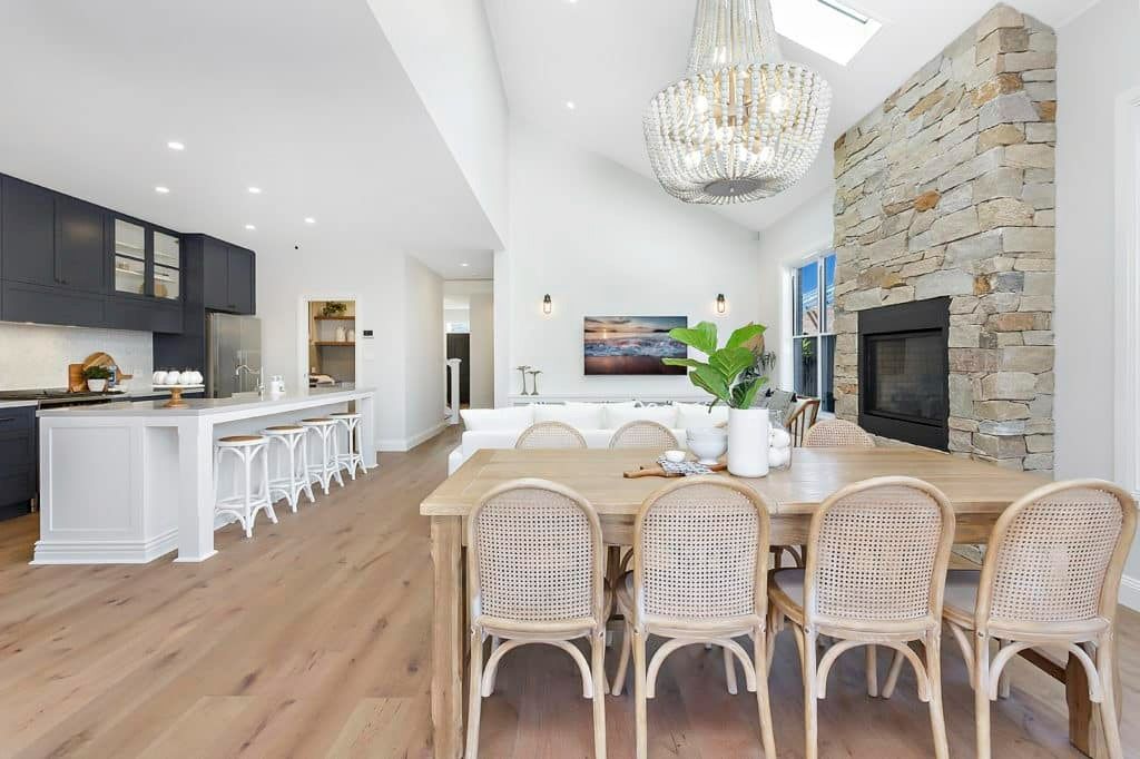 A Dining Room Table and Chairs in A House with A Fireplace — Evolution Building Group Dapto, NSW