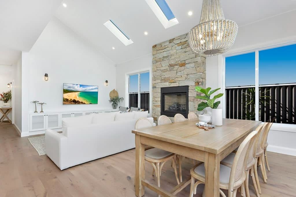 A Living Room with A Dining Table and Chairs and A Fireplace — Evolution Building Group Dapto, NSW