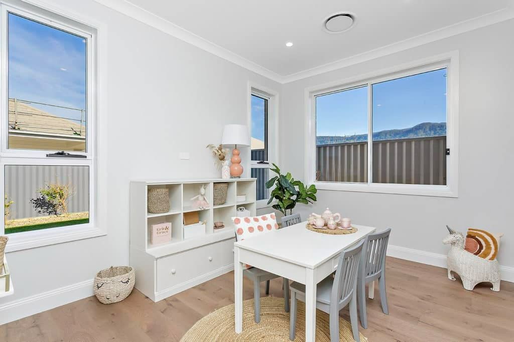 A Living Room with A Table and Chairs and A Window — Evolution Building Group Dapto, NSW