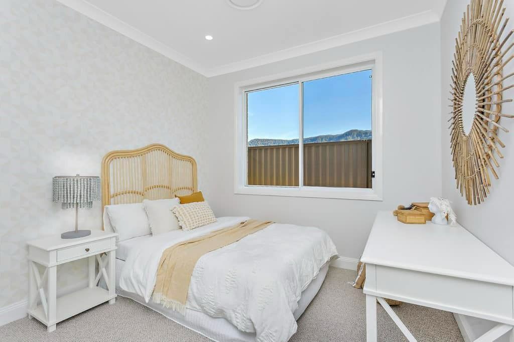 A Bedroom with A Bed, Nightstand, Desk and Window — Evolution Building Group Dapto, NSW