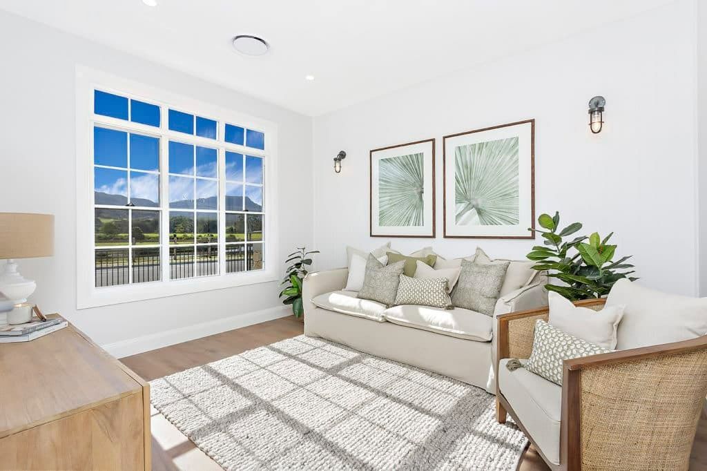 A Living Room with A Couch, Chair, Rug and A Large Window — Evolution Building Group Dapto, NSW