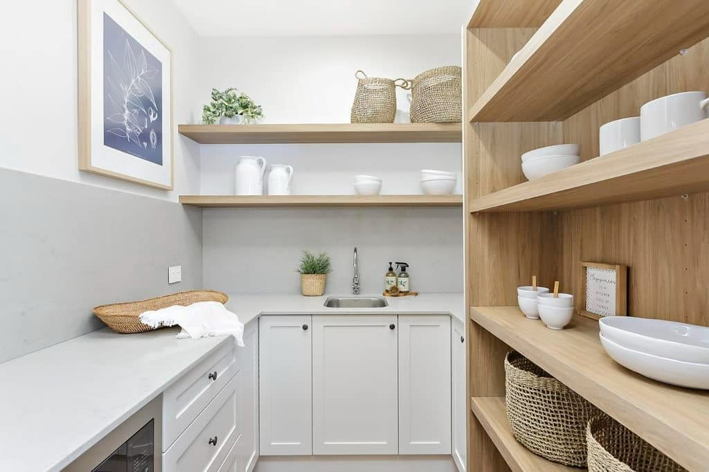 A Kitchen with White Cabinets, Wooden Shelves and A Sink — Evolution Building Group Dapto, NSW