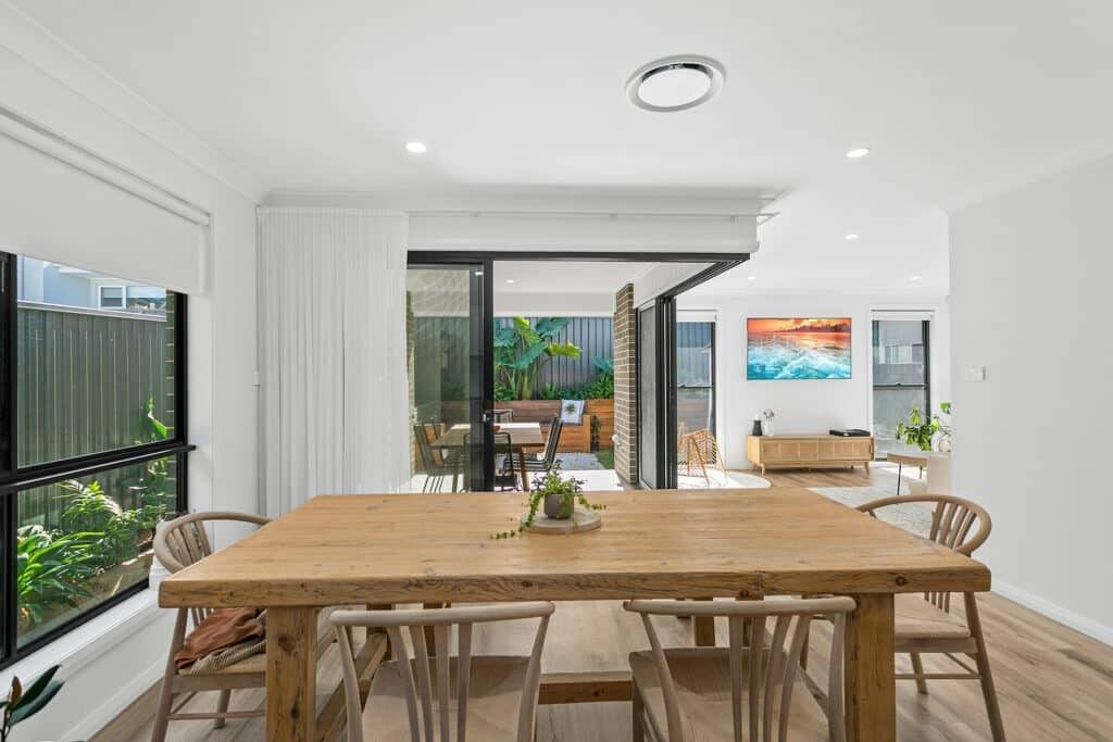 There Is a Wooden Table and Chairs in The Dining Room — Evolution Building Group Dapto, NSW