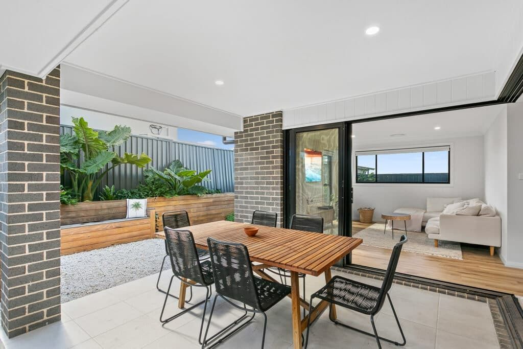 A Patio with A Table and Chairs in A House — Evolution Building Group Dapto, NSW