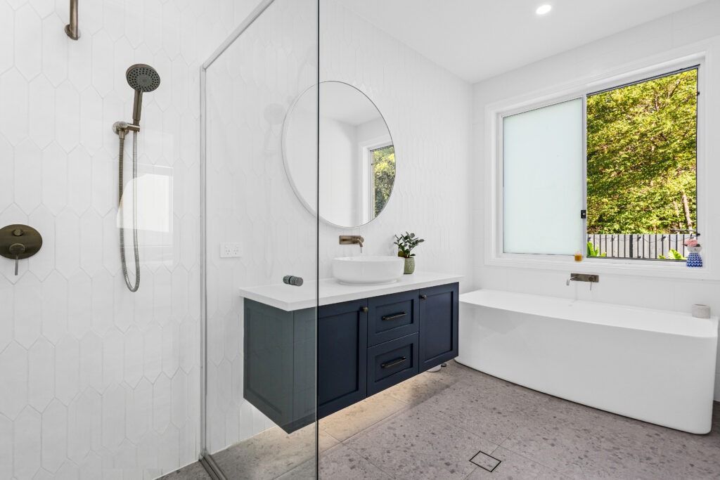 A Bathroom with A Bathtub, Sink, Shower and Mirror — Evolution Building Group Dapto, NSW
