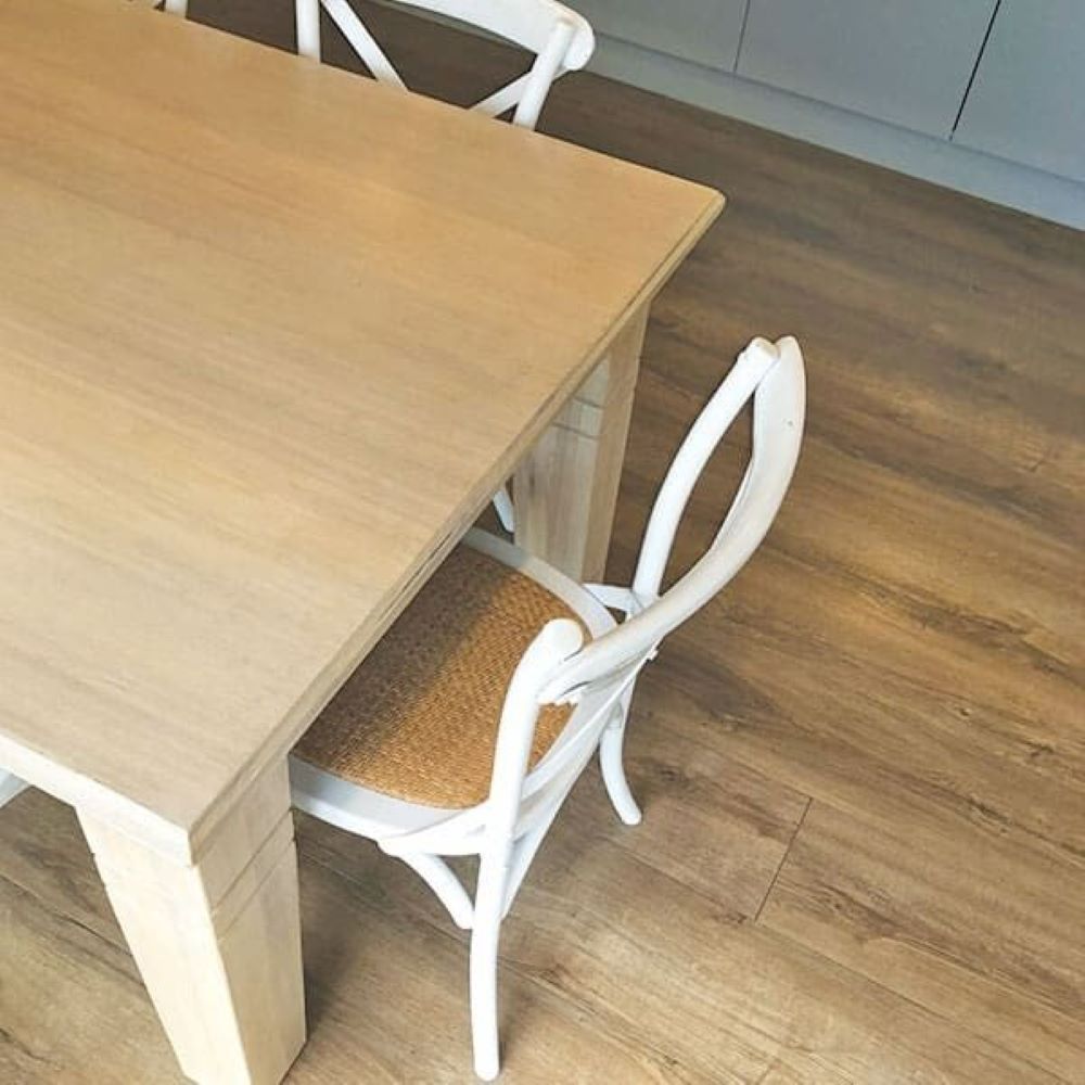 A Wooden Table with Two White Chairs Underneath It — Evolution Building Group Dapto, NSW