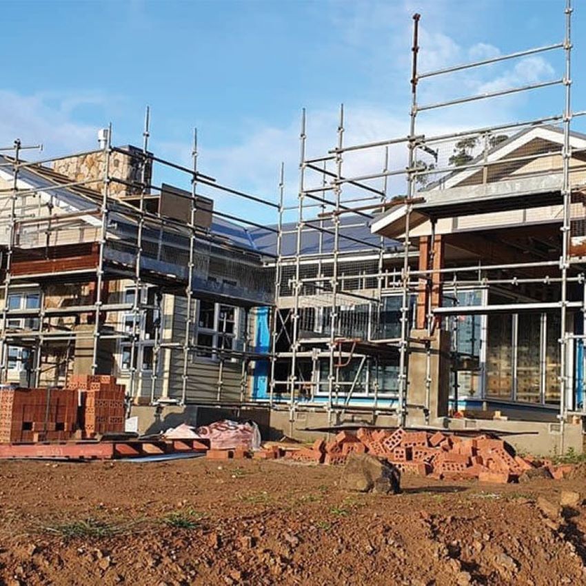A House Is Being Built with Scaffolding Around It — Evolution Building Group Dapto, NSW