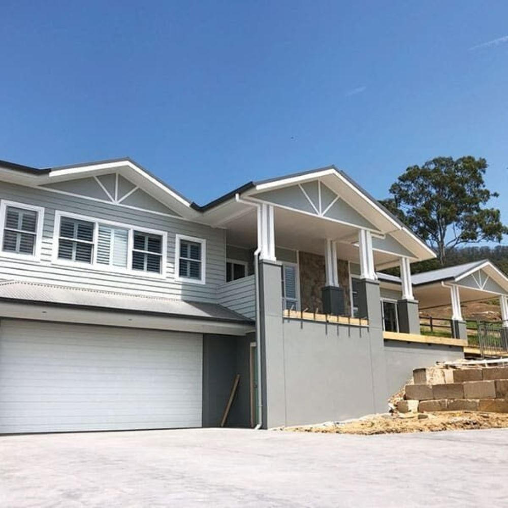 A Large House with A White Garage Door Is Under Construction — Evolution Building Group Dapto, NSW