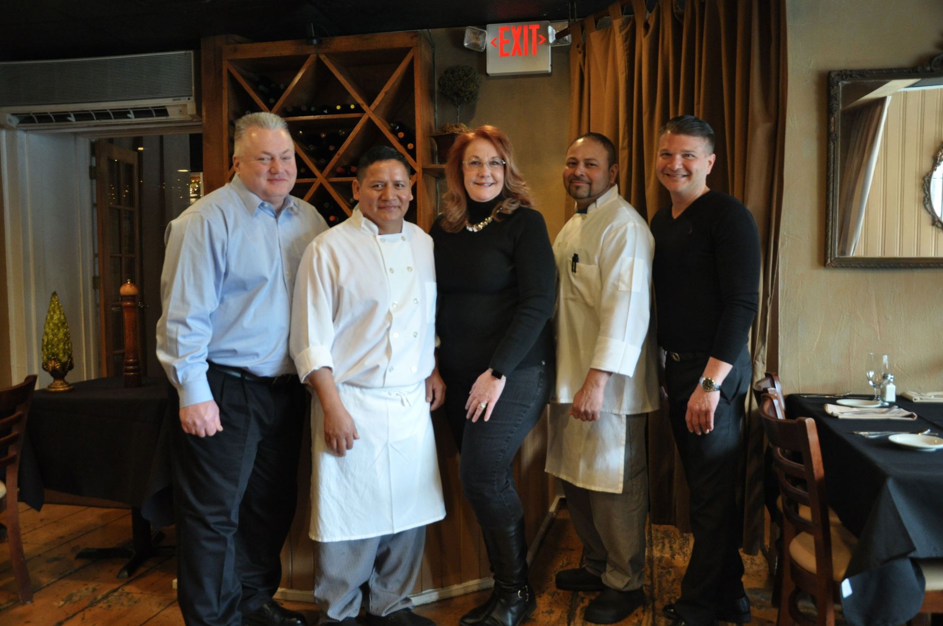 A group of people are posing for a picture in a restaurant.