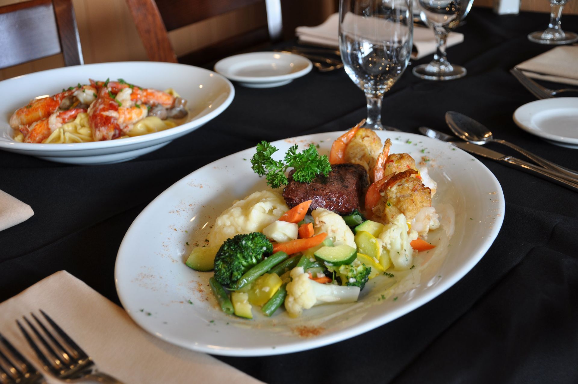 A plate of food with vegetables and meat on a table