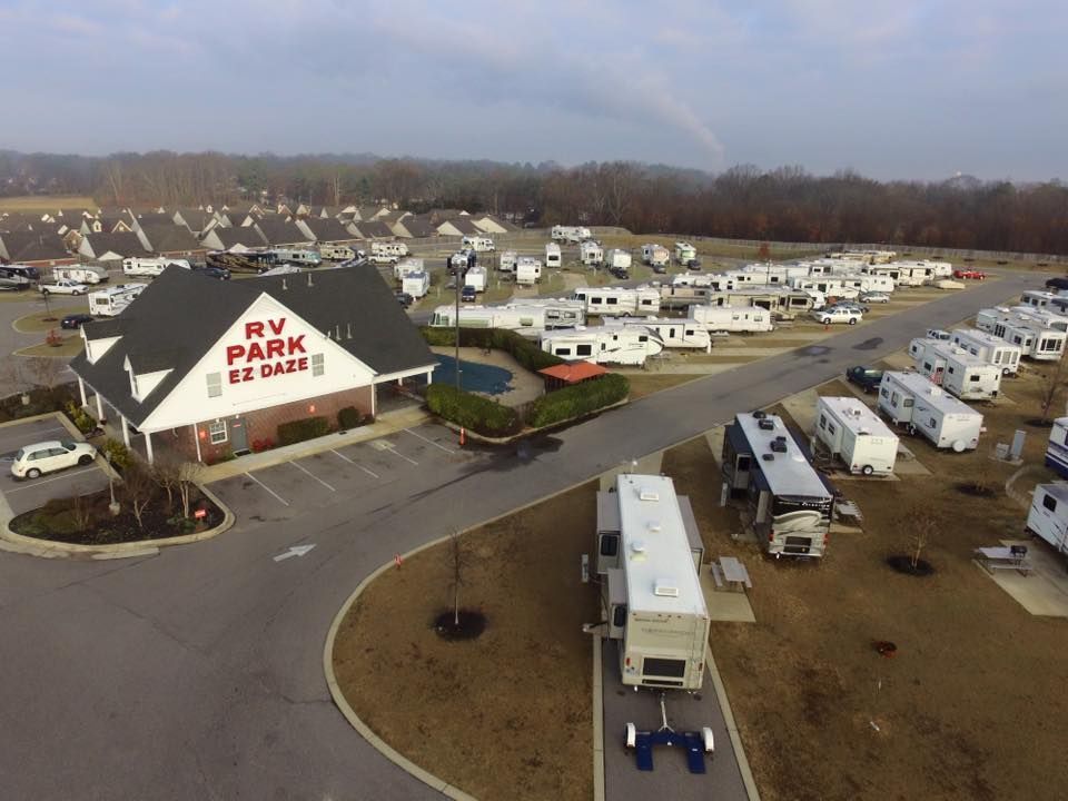 An aerial view of a rv park with a lot of rv 's parked in front of it.