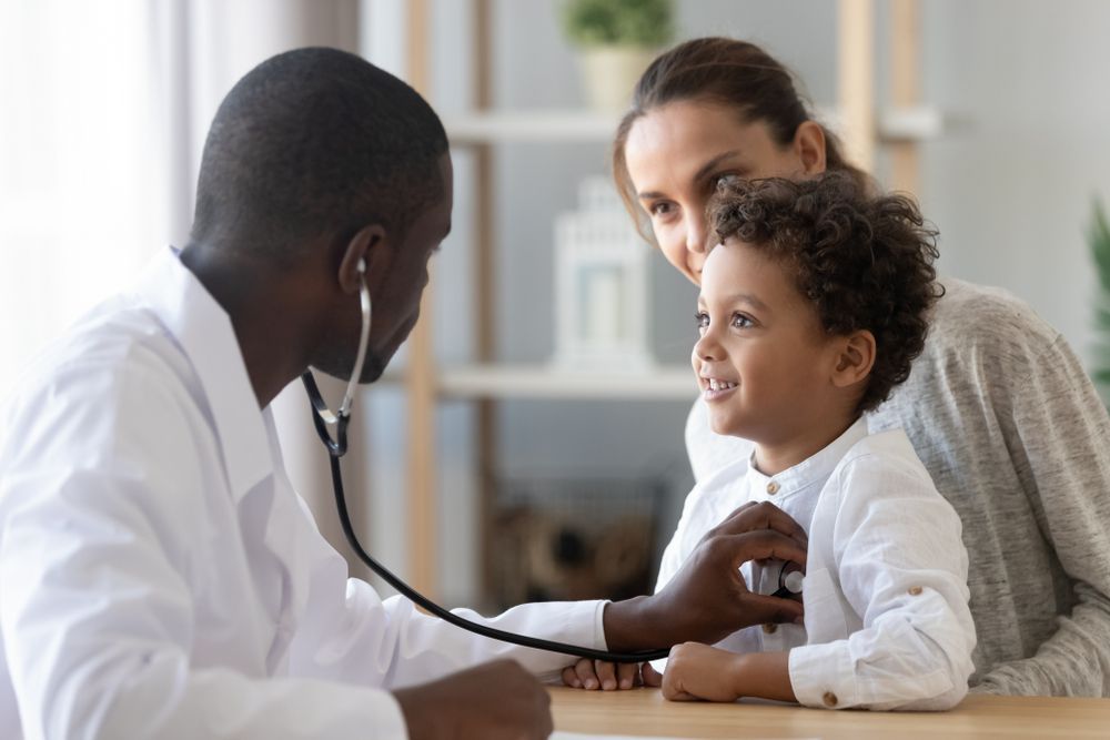 doctor listening to child's lungs using a stethoscope