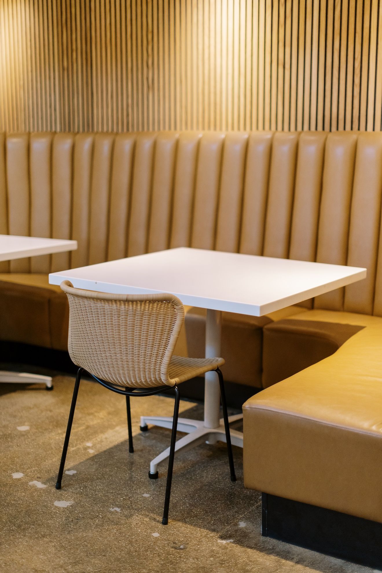 A restaurant with tables and chairs in a booth.