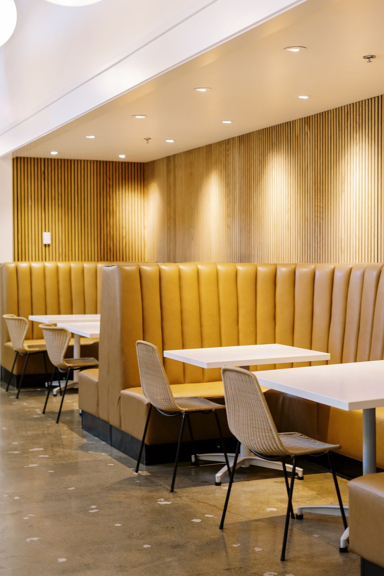 There are many tables and chairs in the restaurant.