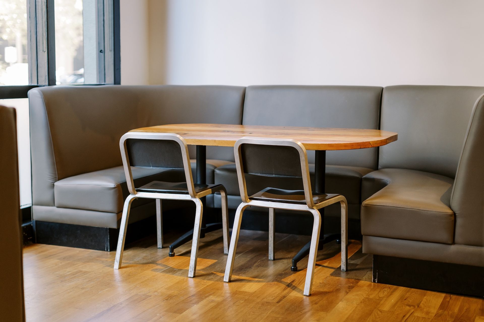 A booth with a table and chairs in a restaurant.