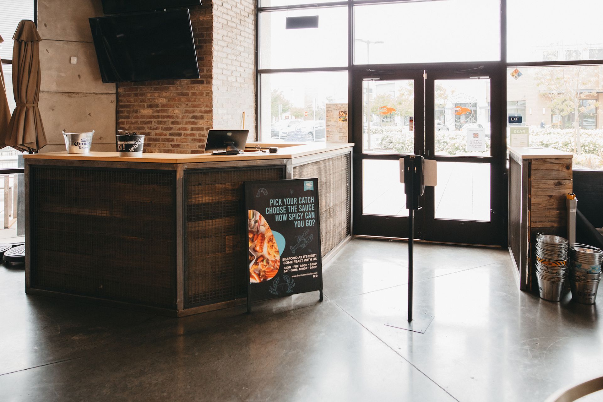 The inside of a restaurant with a counter and a sign