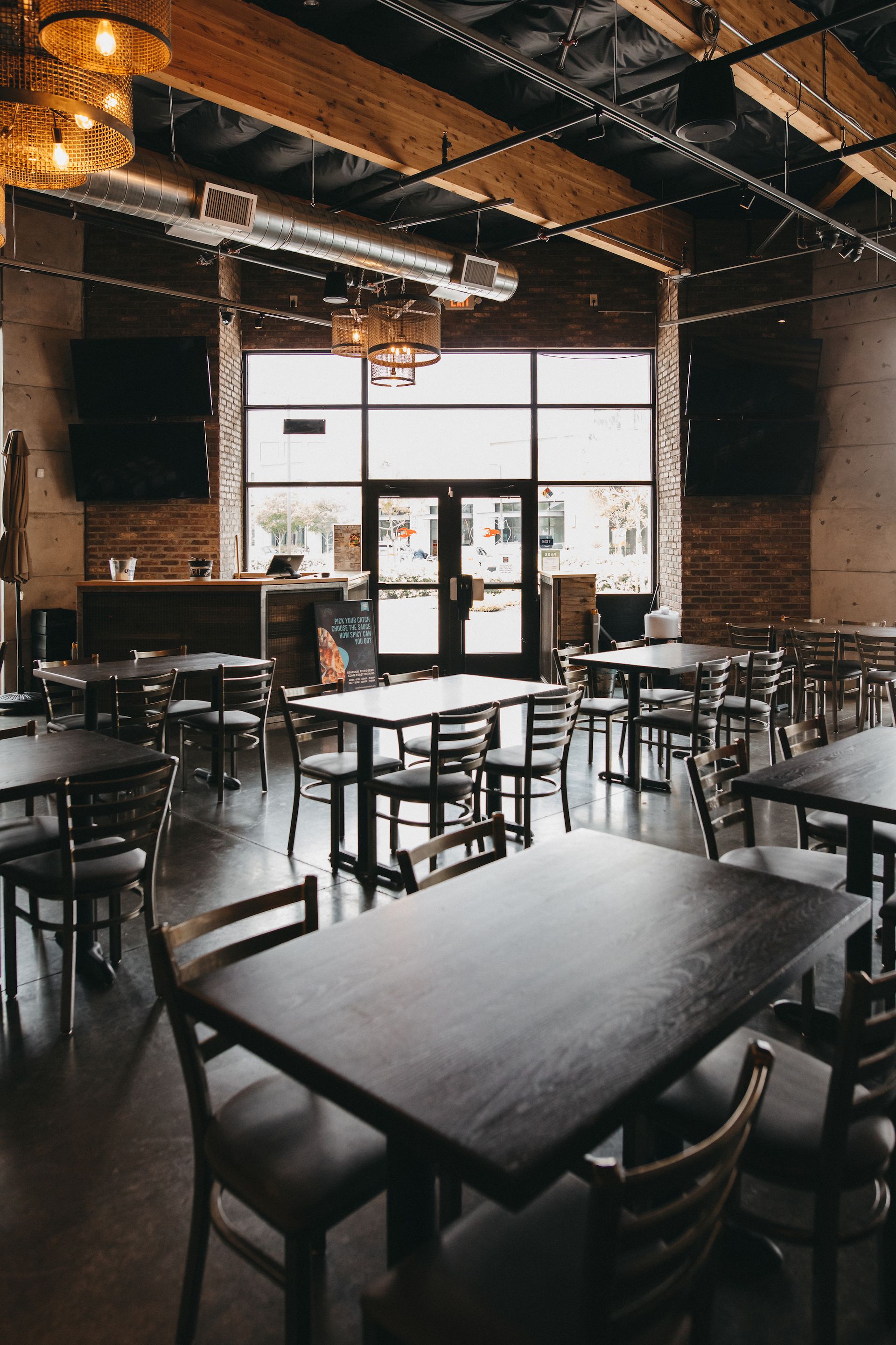 A restaurant filled with tables and chairs and a large window.