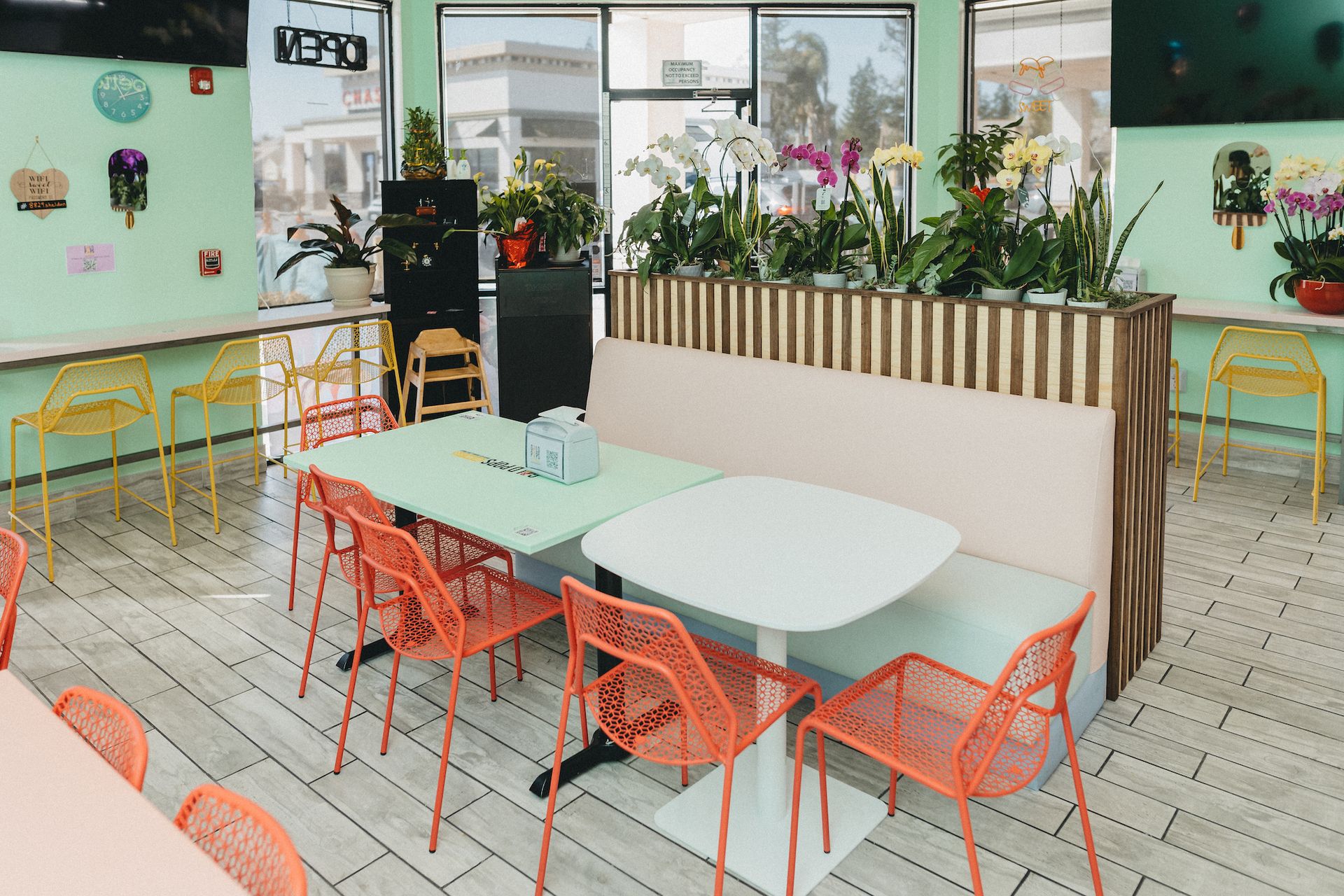A restaurant with tables and chairs and a bench.