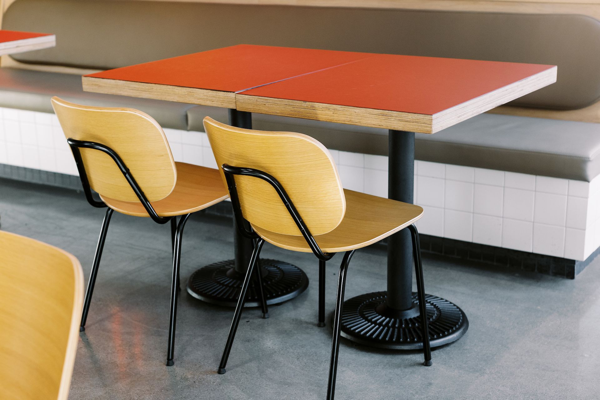Two chairs are sitting next to a table in a restaurant.