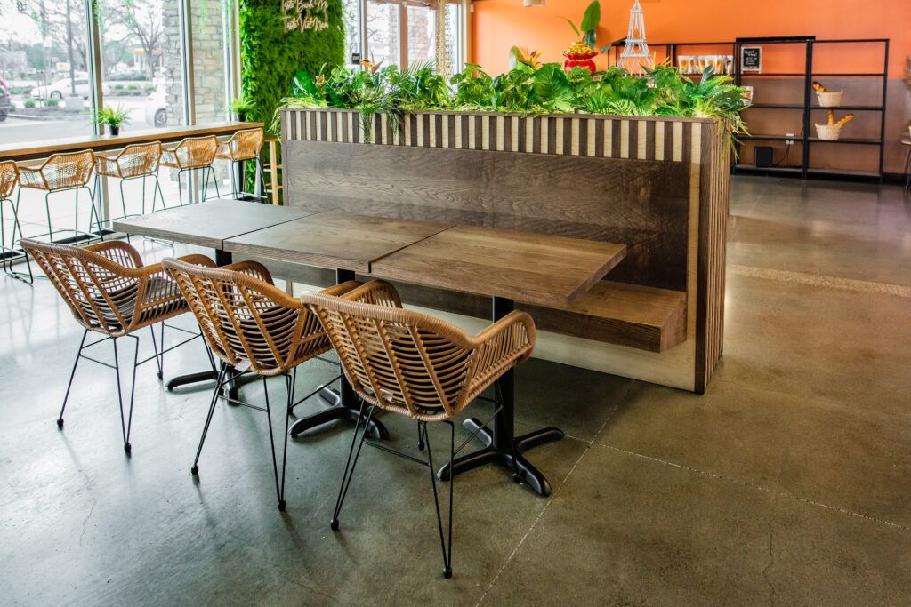 A restaurant with tables and chairs and a bench.