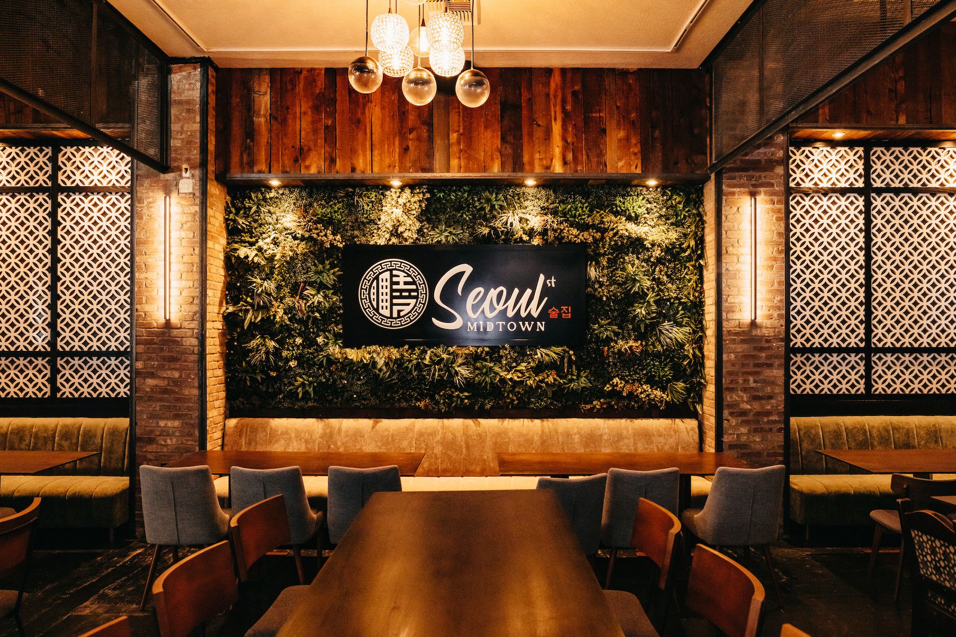 A restaurant with a table and chairs and a sign that says seoul