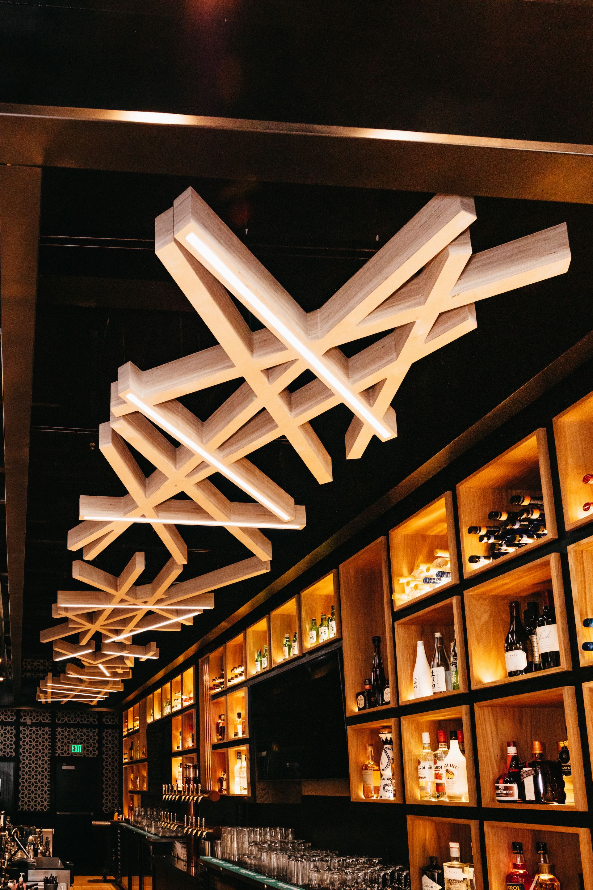 A bar with a lot of bottles on shelves