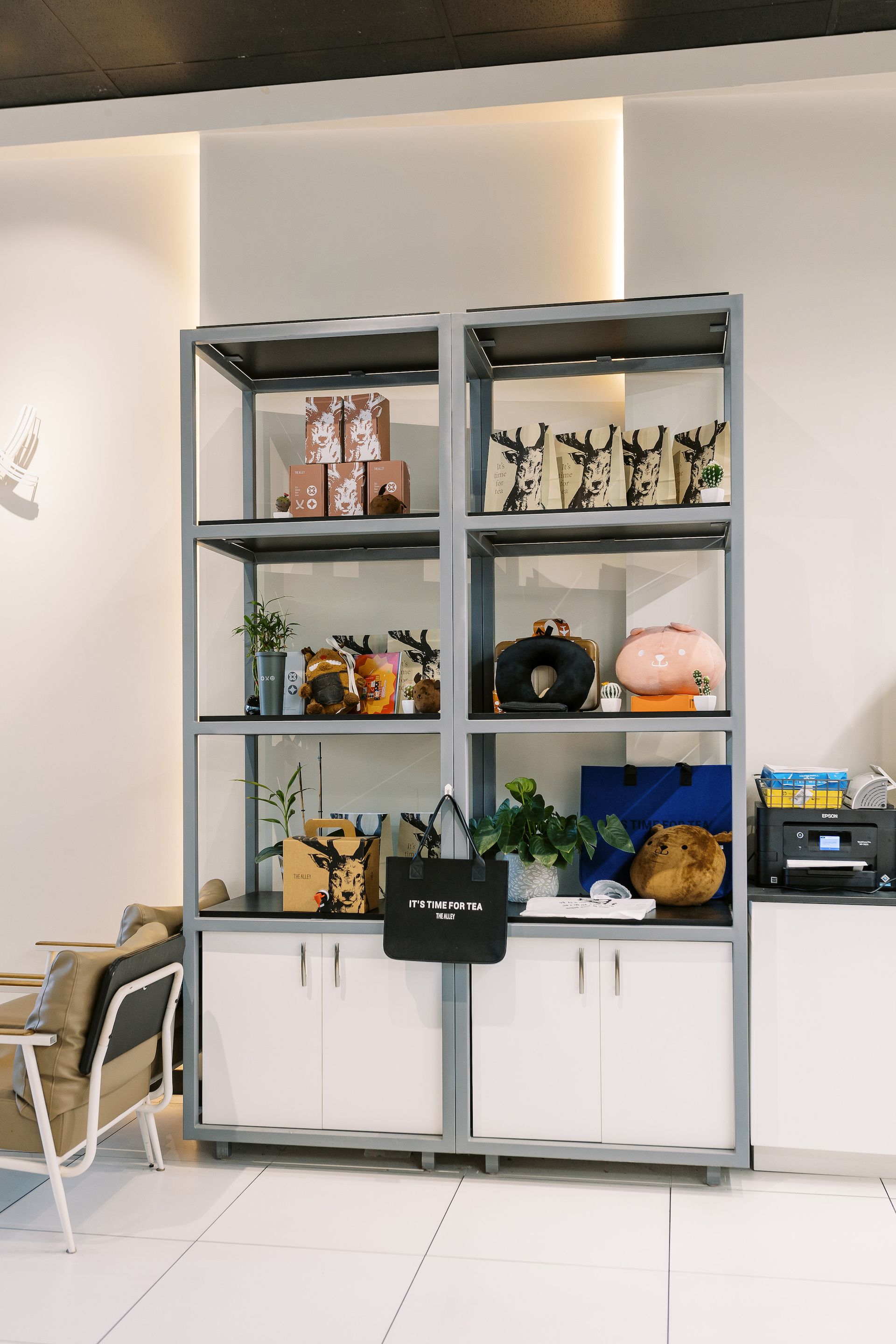 A restaurant with a shelf filled with lots of items and a chair.
