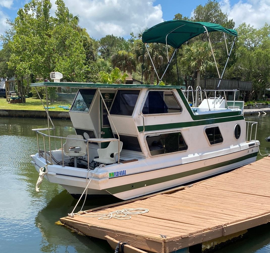 A boat is docked at a dock on a river.