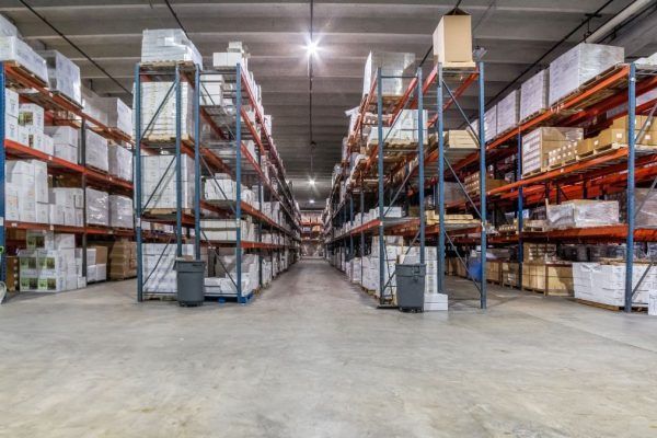 A large warehouse filled with lots of shelves and boxes.