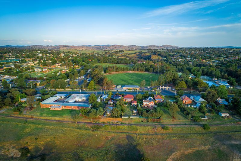 An aerial view of a small town with a field in the middle of it — Hydro Excavation in Yass, NSW