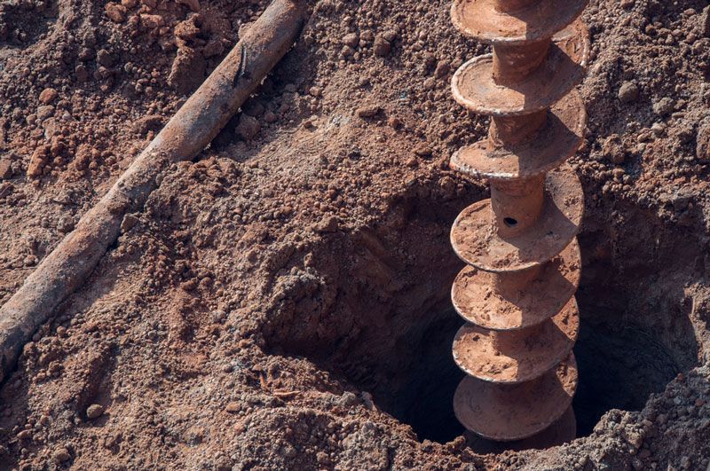 A close up of a drill bit in the dirt — Hydro Excavation in Moss Vale, NSW