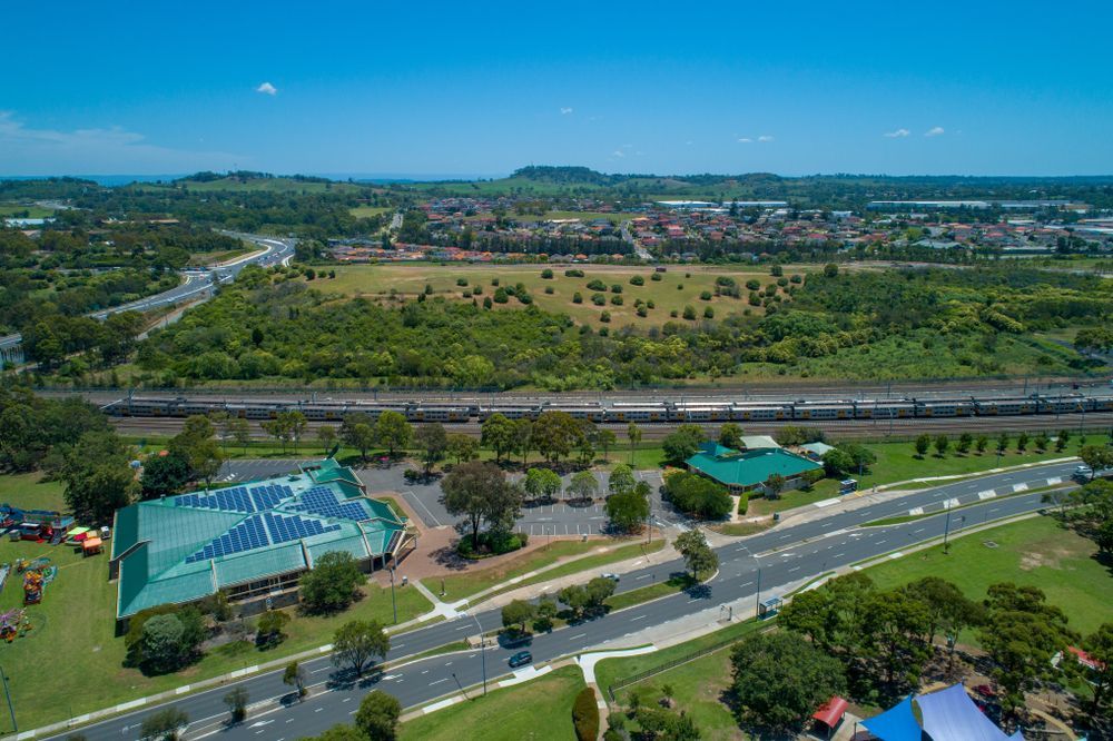 An aerial view of a park with a train going by — Hydro Excavation in Campbelltown, NSW