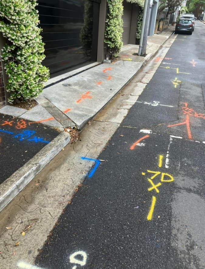 A Row Of Numbers Are Painted On The Side Of A Road — East Coast Locating Services In Maitland, NSW