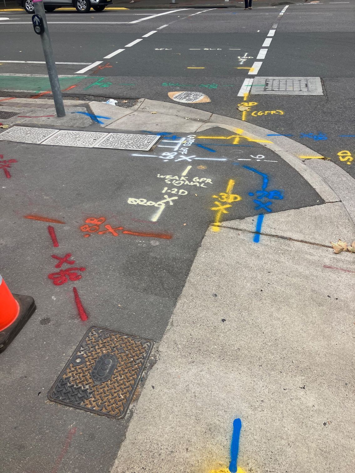 A corner of a street with arrows painted on it.