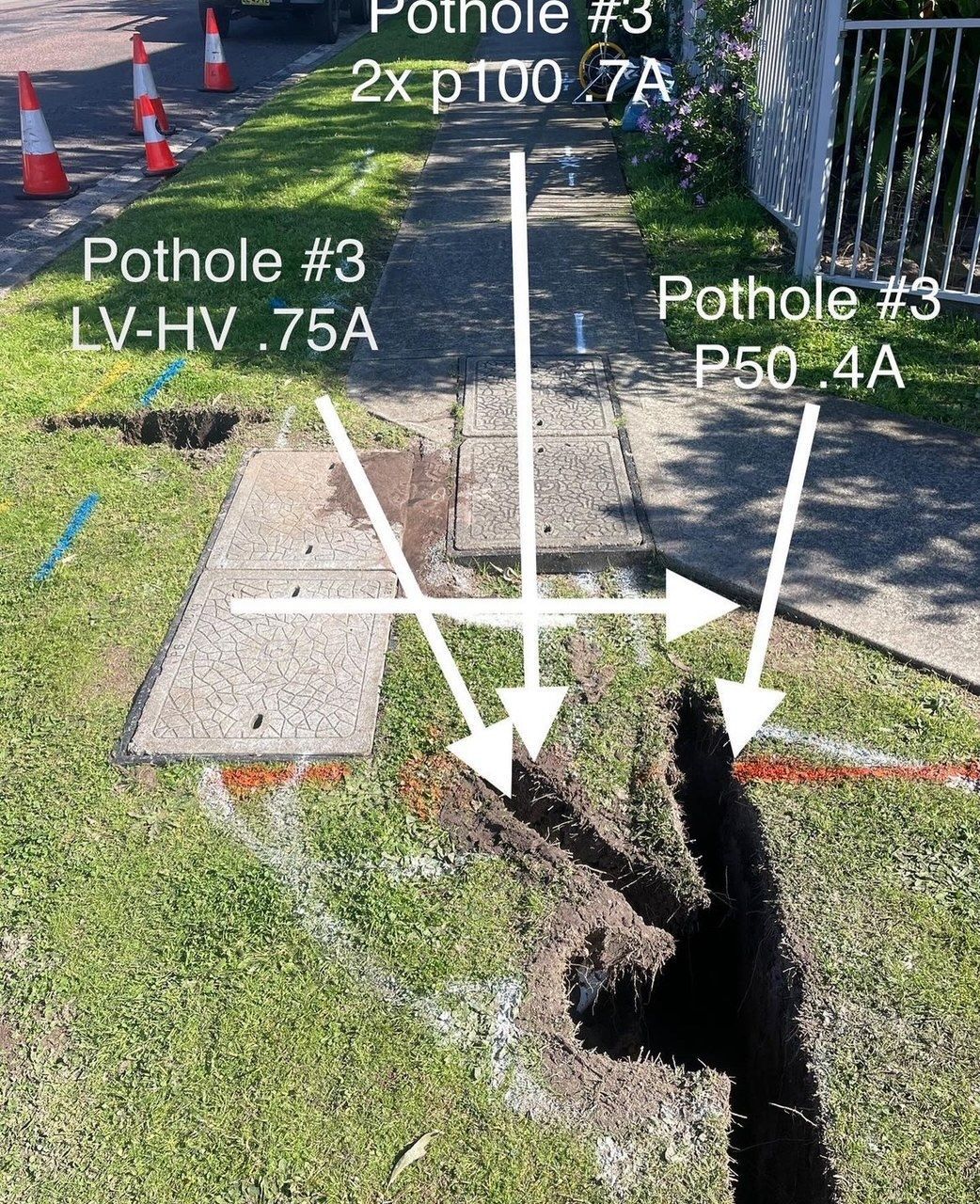 A picture of a pothole with arrows pointing to it