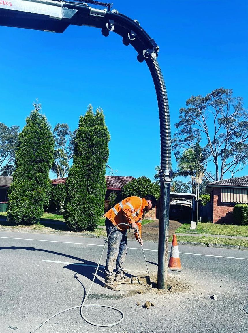 A Vacuum Truck Is Parked On The Side Of The Road — East Coast Locating Services In Wallalong, NSW