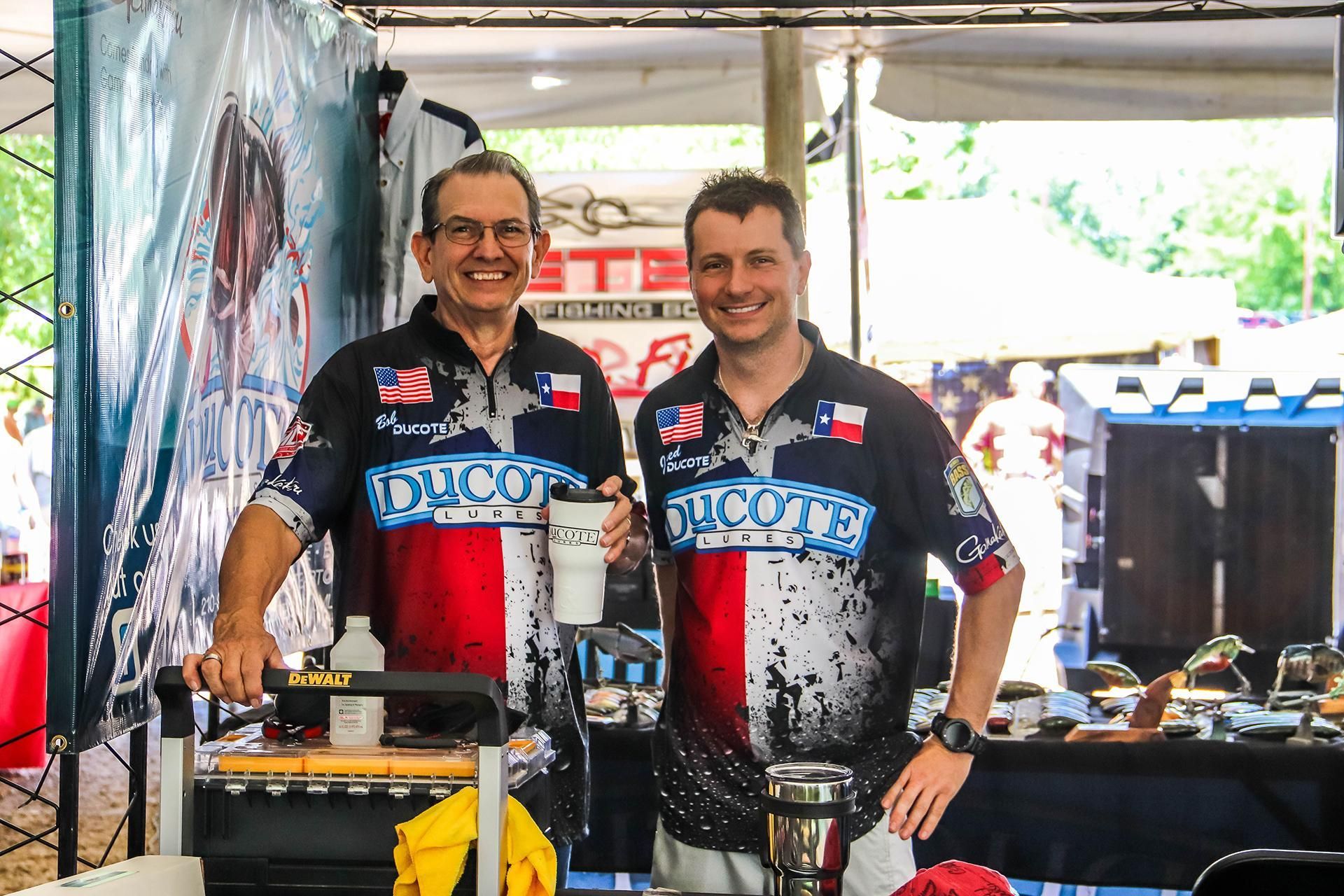 two men are standing next to each other wearing shirts that say duco