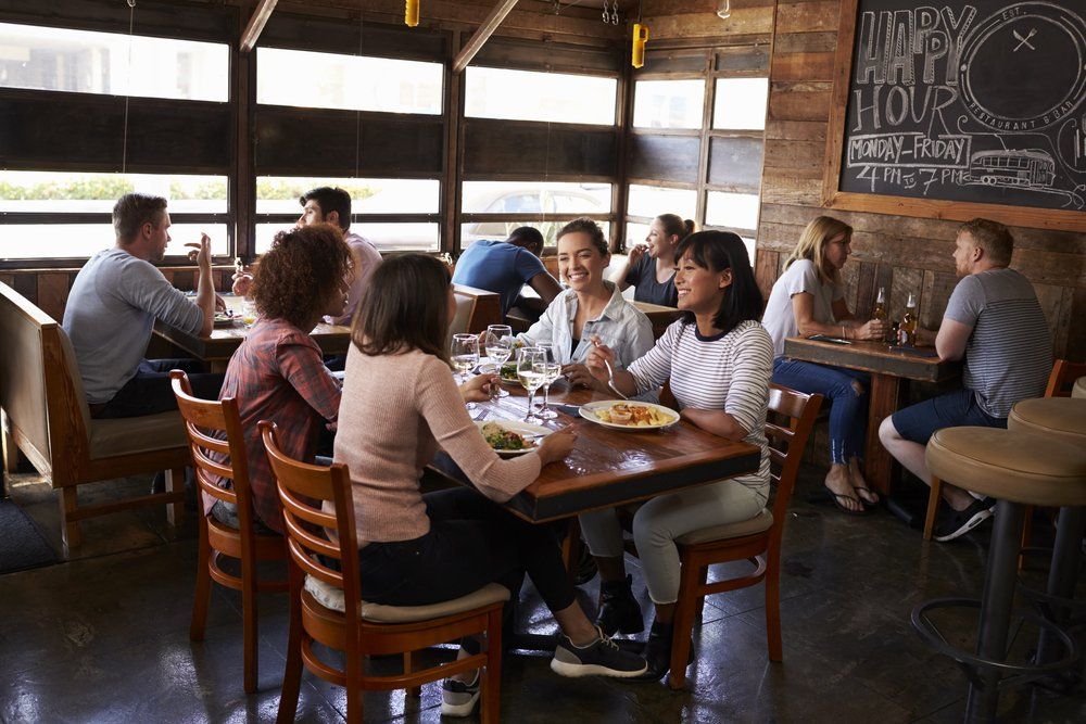 female friends at lunch in busy restaurant