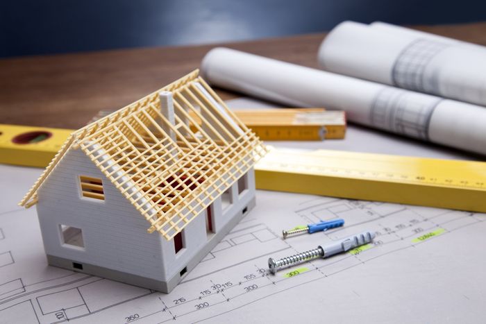 construction plans with helmet and drawing tools