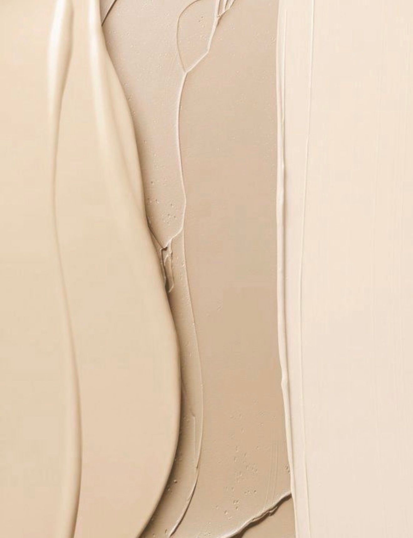Abstract, close-up of light brown, fluid-like paint strokes with a smooth, vertical section on the right.