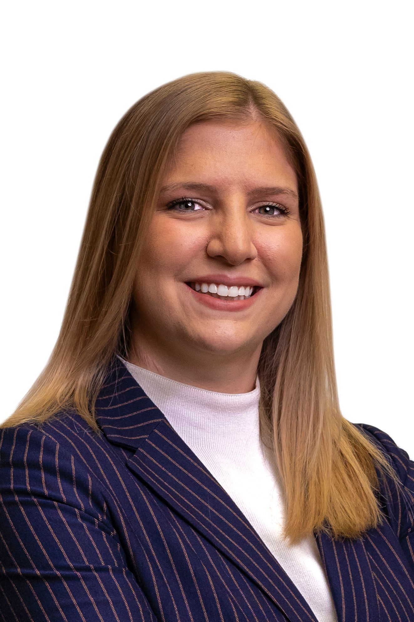 A woman in a blue striped jacket is smiling for the camera.