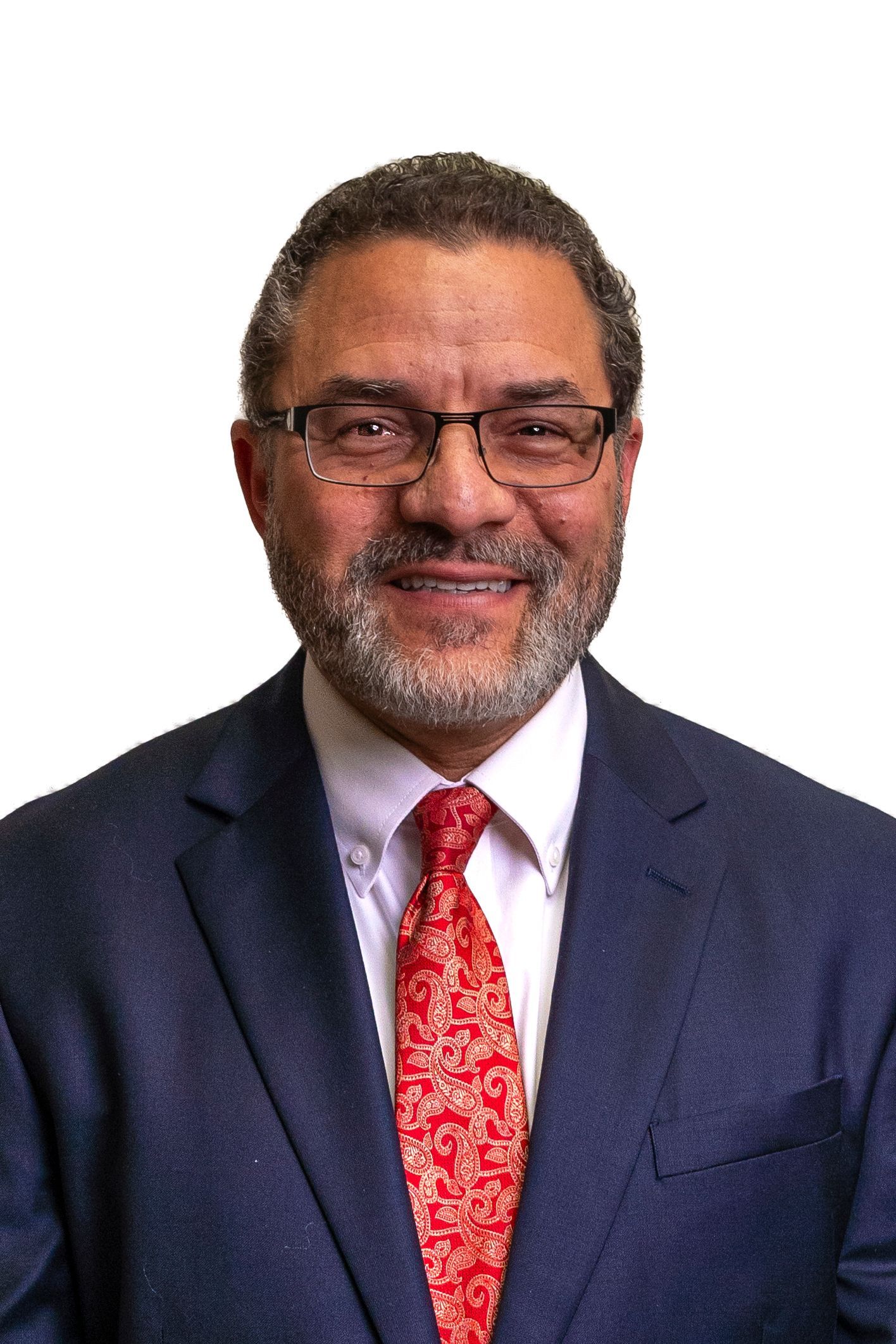 A man in a suit and tie is smiling for the camera.