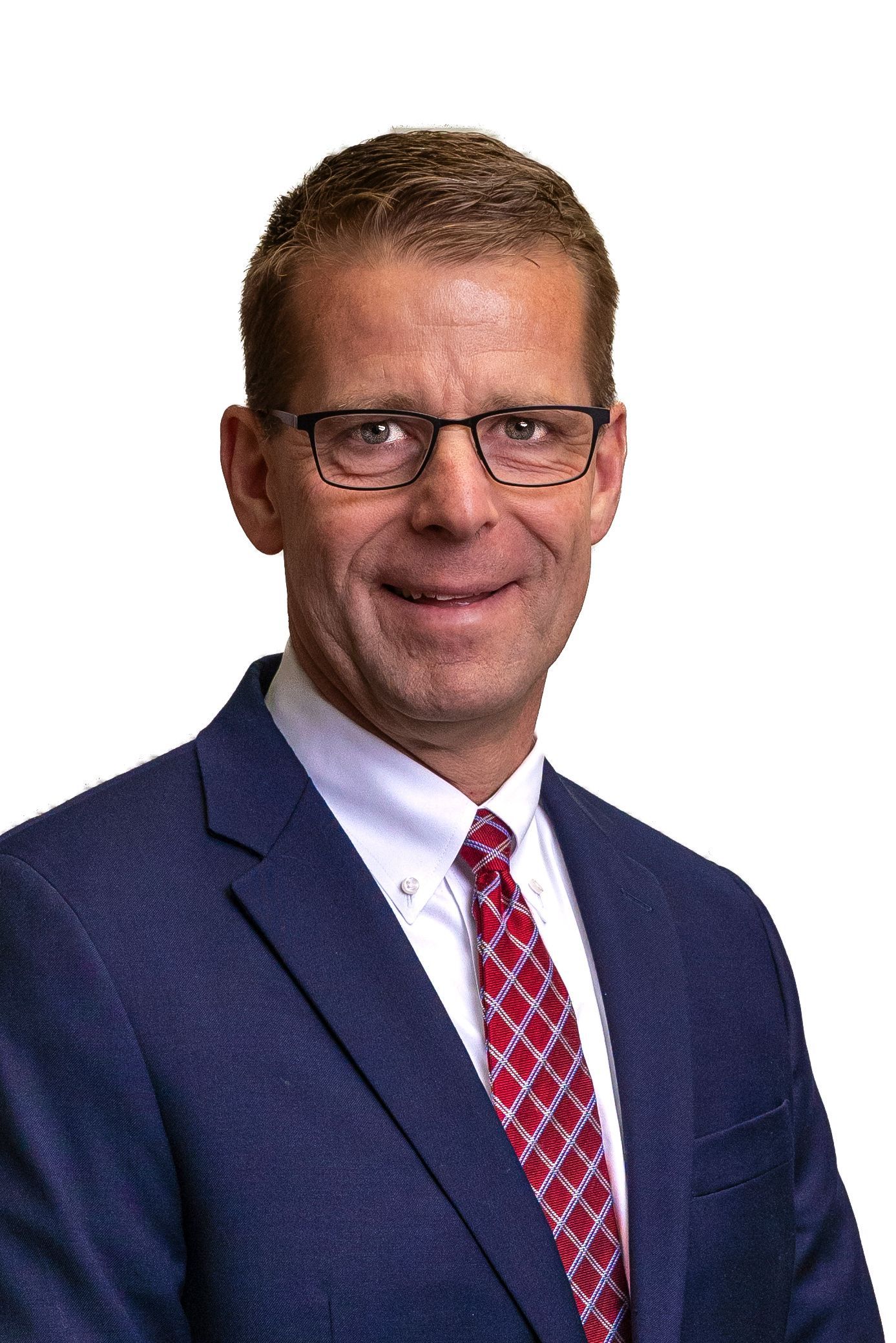 A man in a suit and tie is smiling for the camera.