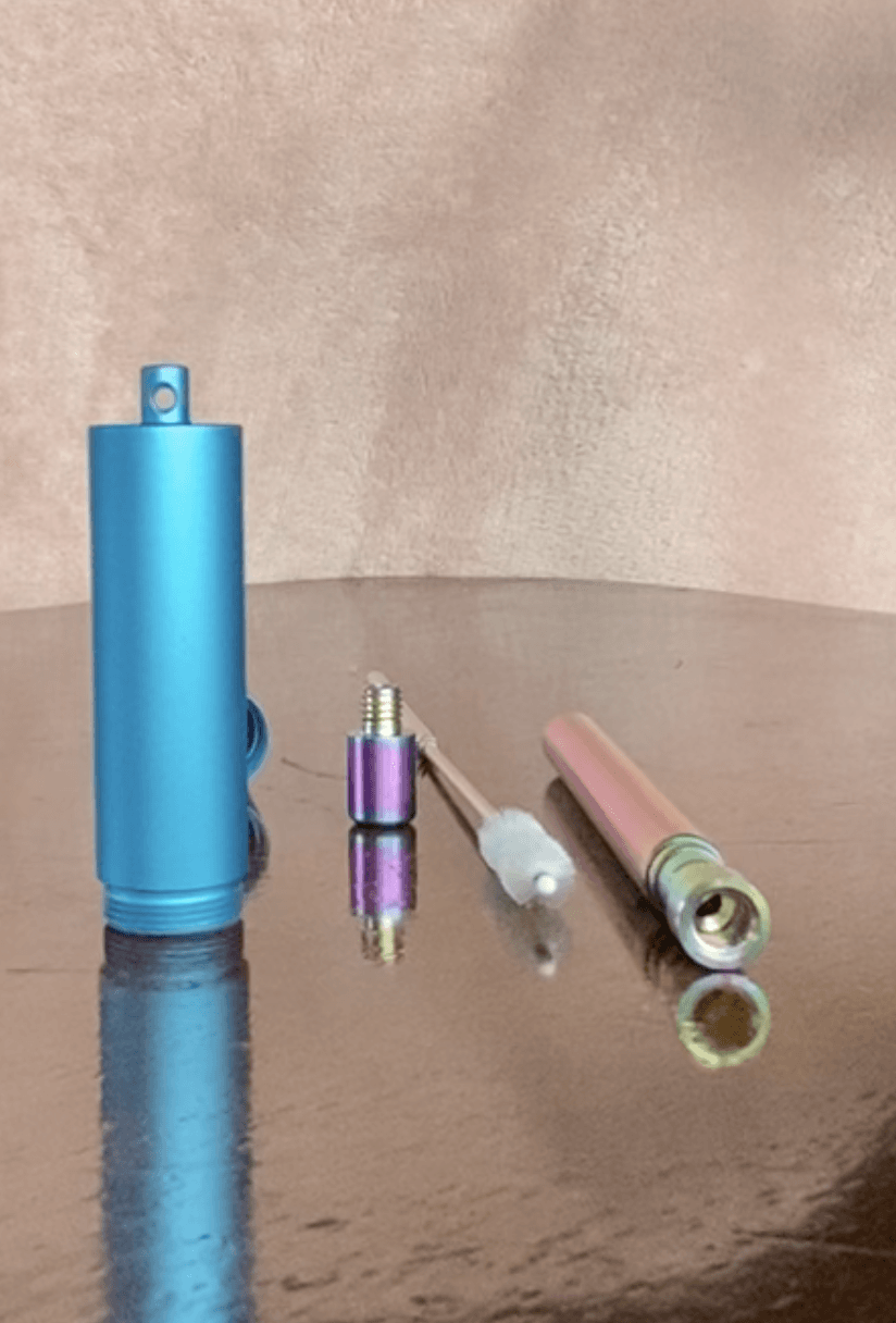 A blue container with a purple top sits on a wooden table