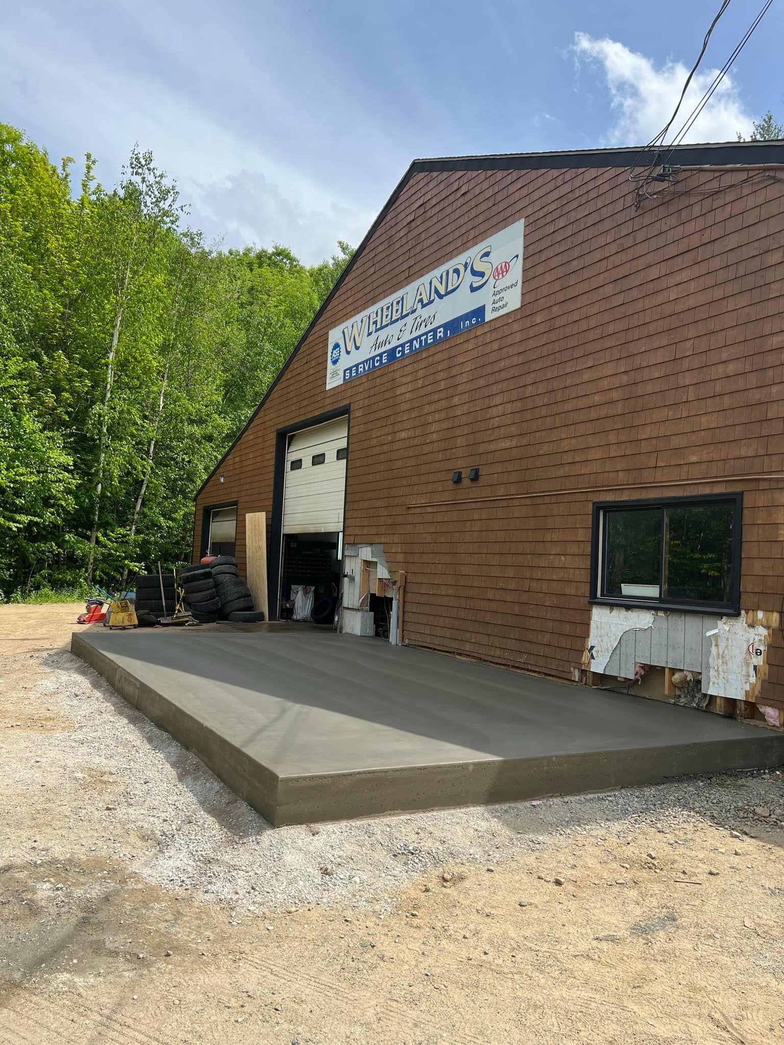 A large building with a concrete patio in front of it.
