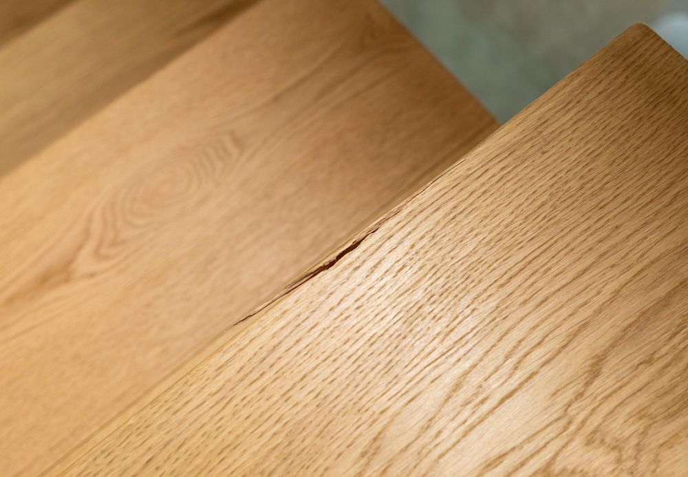 Close-up of light wood flooring with warm, diagonal grain patterns