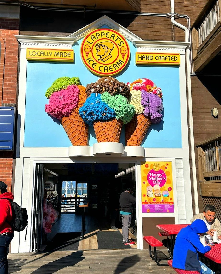Gelateria storefront with colorful ice cream cones sign above the entrance